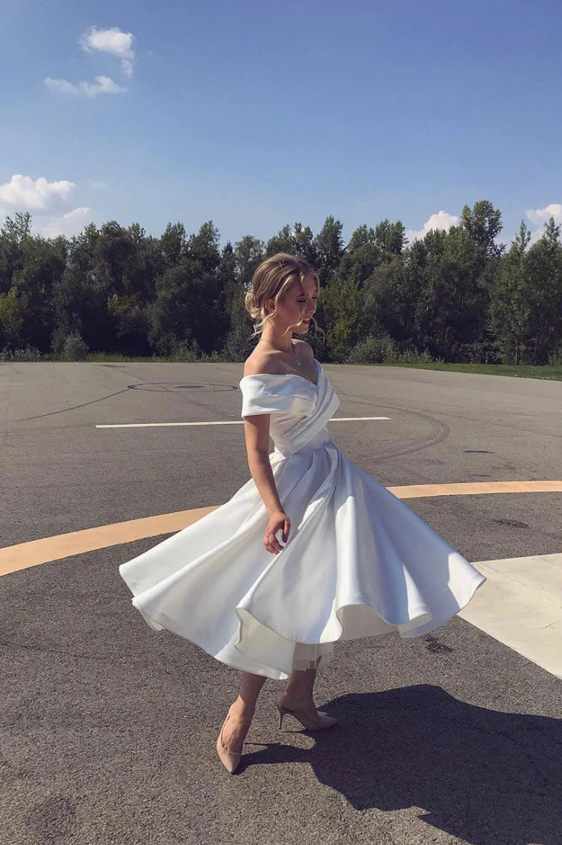 Elegant white off-shoulder satin tea-length prom dress.