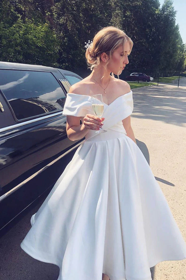 Side view of white off-shoulder satin tea-length evening dress.