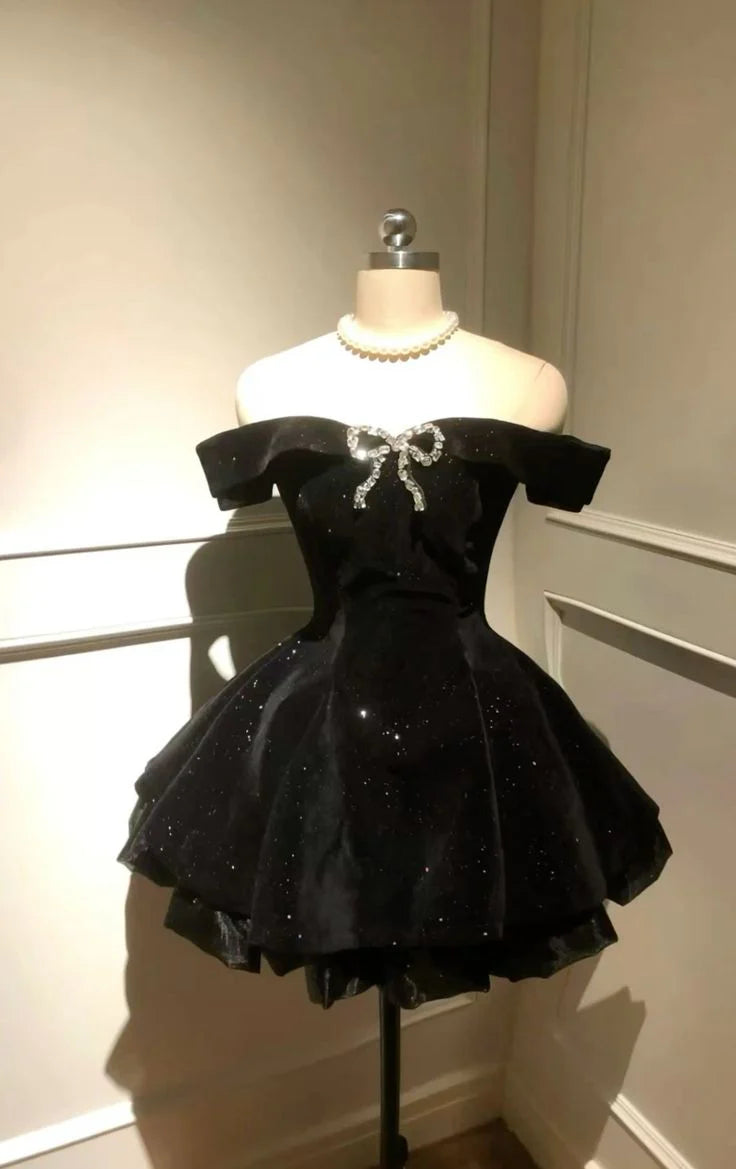 Elegant black velvet off-shoulder short dress with beaded embellishments.