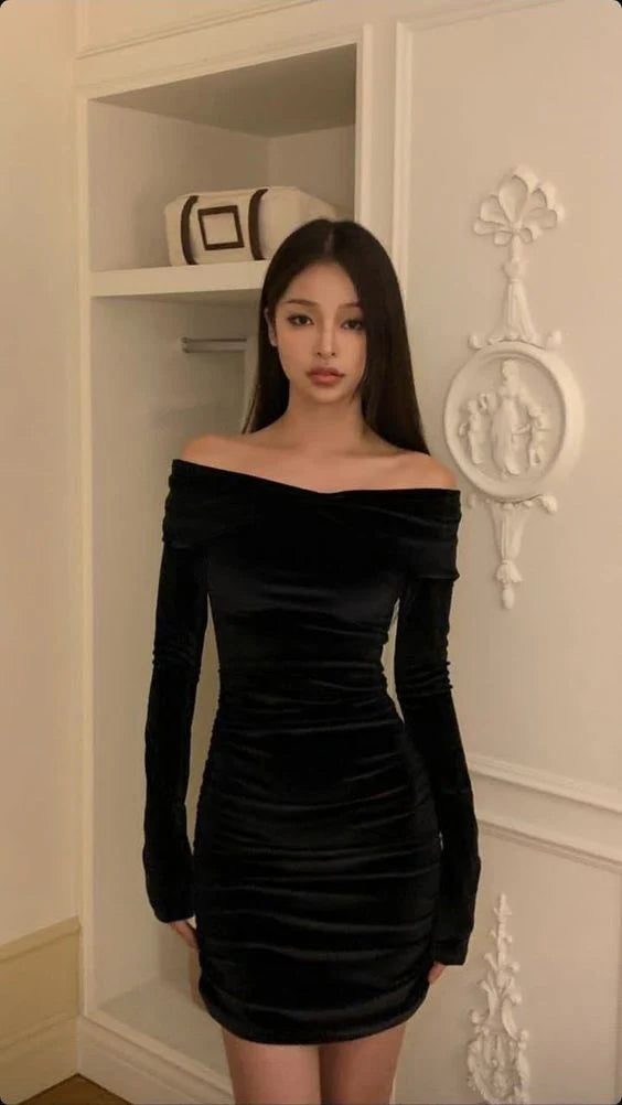 Woman wearing an elegant black off-shoulder velvet short homecoming dress.