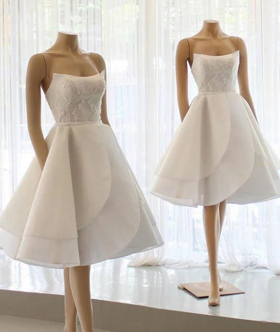 Model wearing a white off-shoulder short homecoming dress with a flattering retract waist.