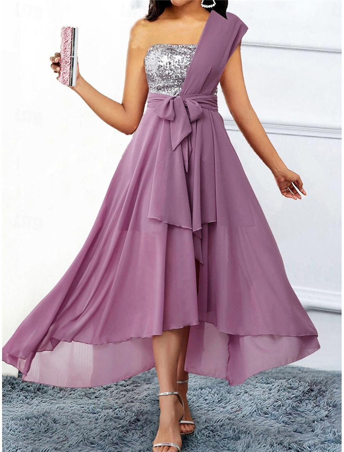 Woman wearing an elegant light purple one-shoulder chiffon formal gown.