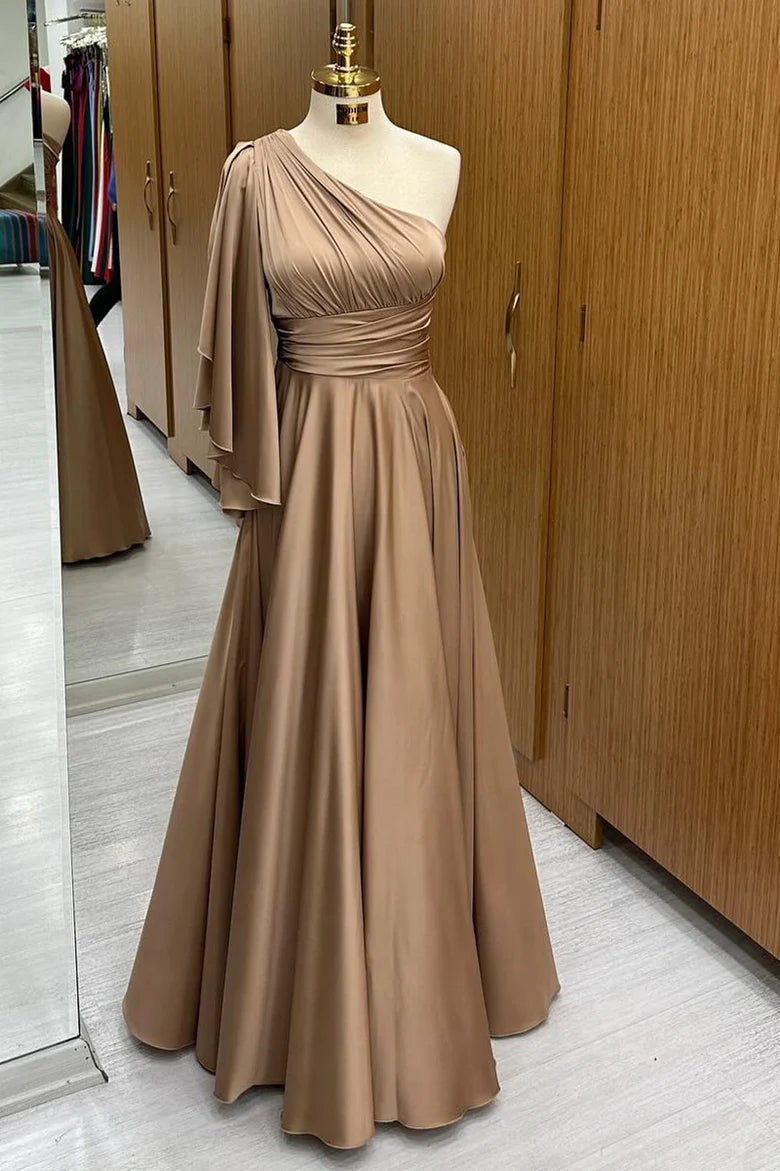 Elegant woman in a champagne one-shoulder flared sleeve A-line long formal dress, front view.