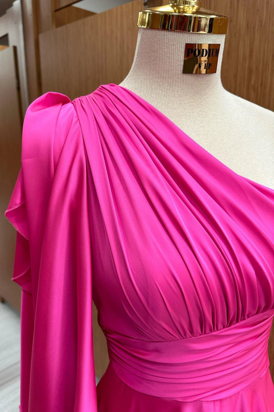 Full-length view of a woman posing gracefully in the champagne formal dress.