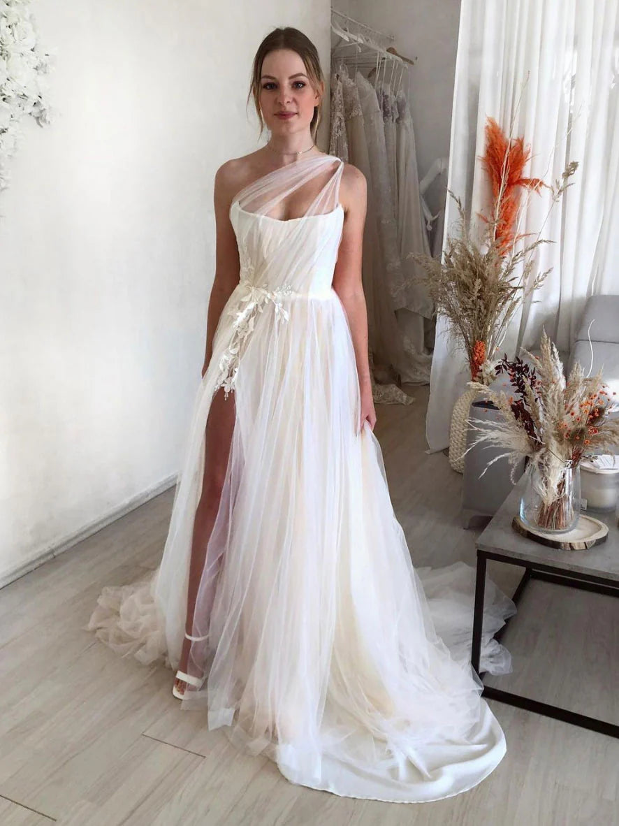 Model wearing a light champagne one-shoulder lace tulle long prom dress.