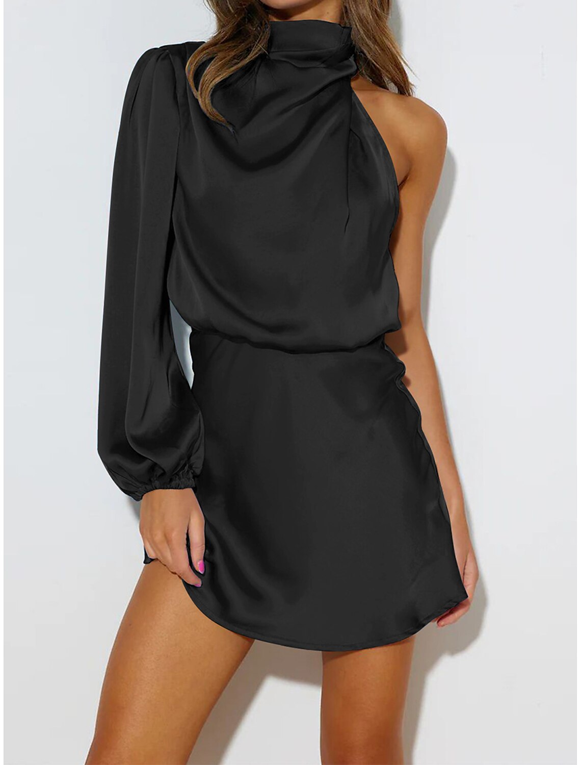 Woman wearing a green one-shoulder long sleeve mini cocktail dress.