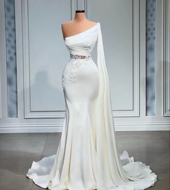 White one-shoulder mermaid wedding dress with intricate lace applique.