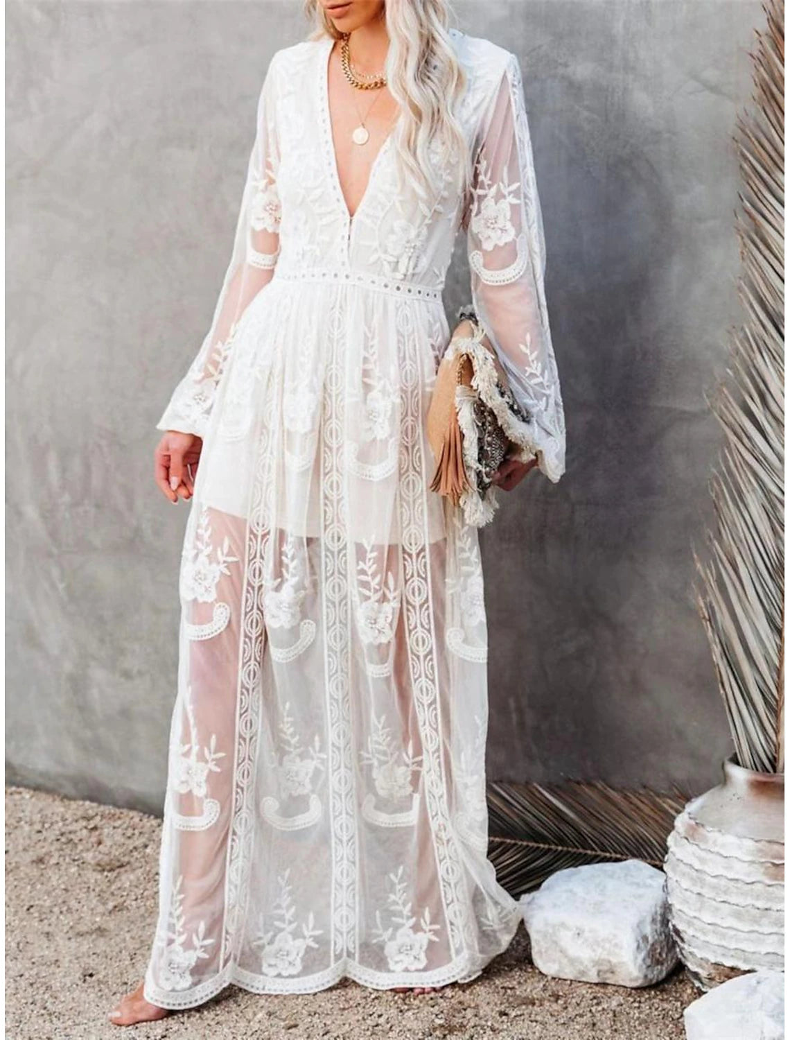 Woman wearing an elegant white patchwork V-neck long sleeve maxi dress.