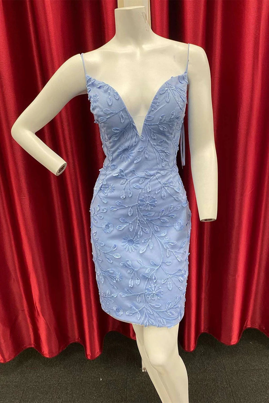 Front view of a woman wearing a periwinkle appliques plunge V-neck mini party dress.