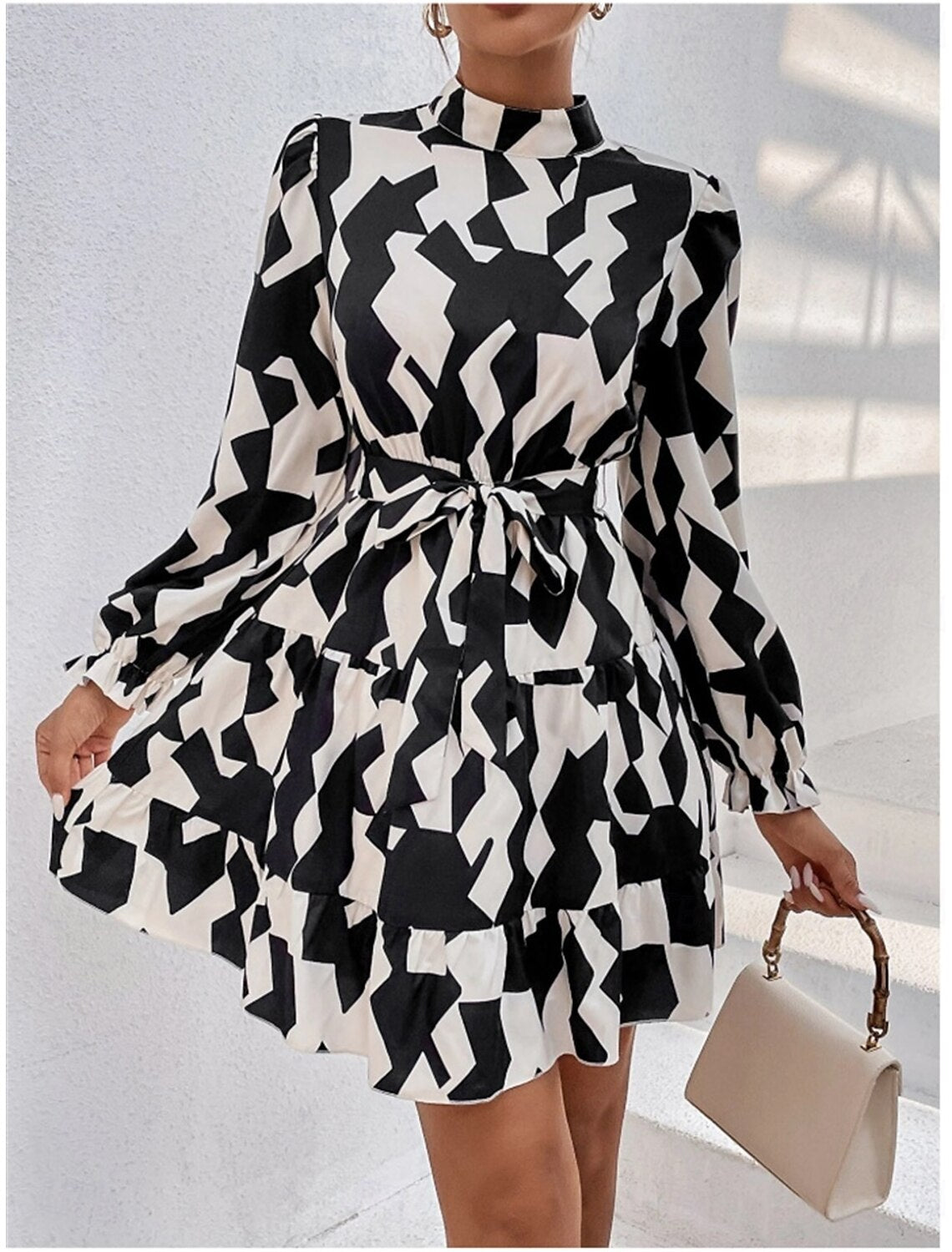 Woman posing in the elegant dark petite A-line ruffle graphic long sleeve stand collar party dress, showing movement.