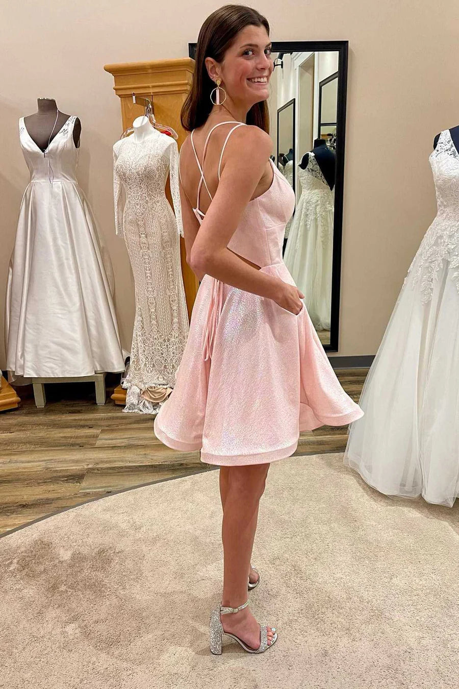 Back view of the pink A-line homecoming dress, highlighting the intricate lace-up detail.