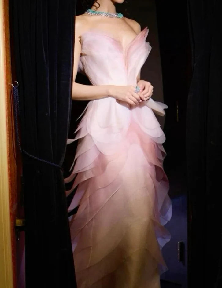 Side view of pink mermaid evening gown with elegant silhouette.