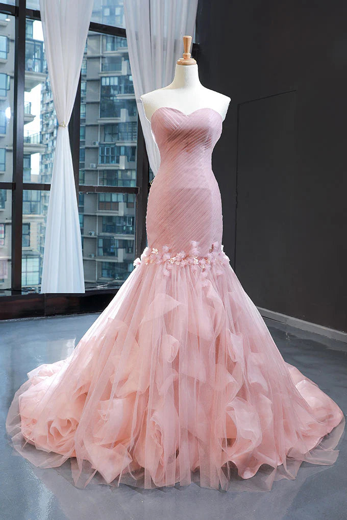 Model wearing a pink sweetheart tulle mermaid long prom dress, front view.