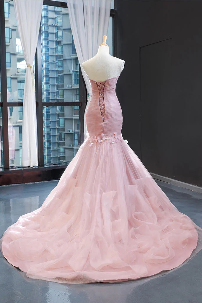 Model in a pink slim-fit mermaid evening gown, side view.