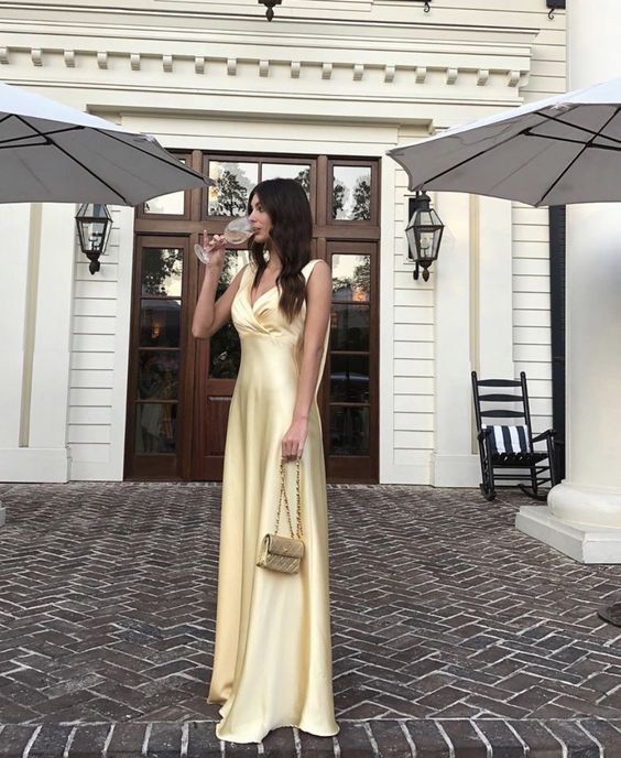 Side view of the yellow A-line V-neck pleated long prom dress, showing pleat details.
