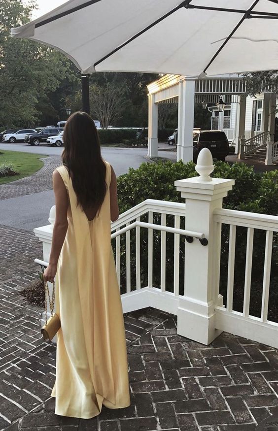 Back view of the yellow A-line V-neck pleated long prom dress, highlighting the flowing skirt.