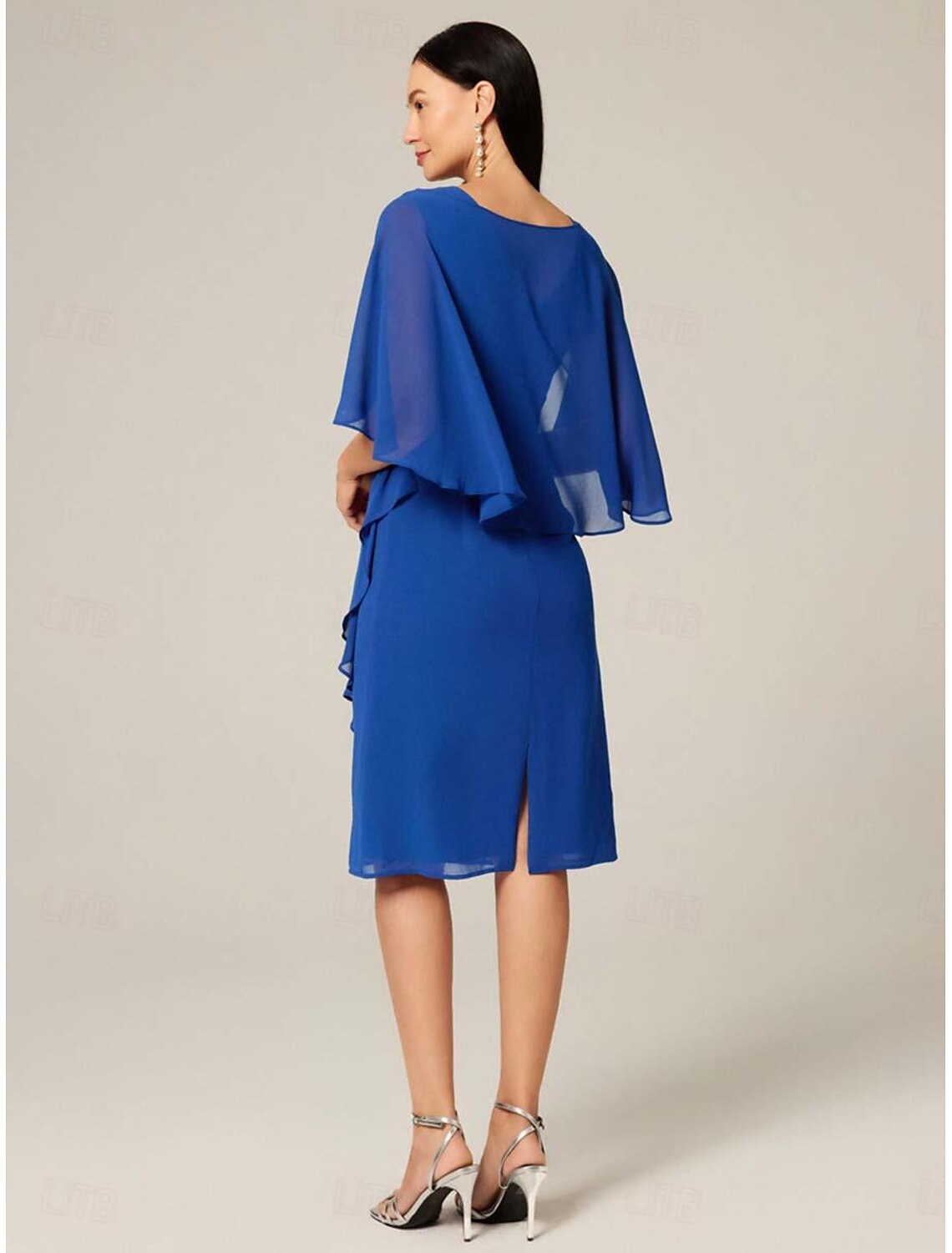 Side view of a woman in a royal blue plus size midi dress, showcasing the chiffon fabric.