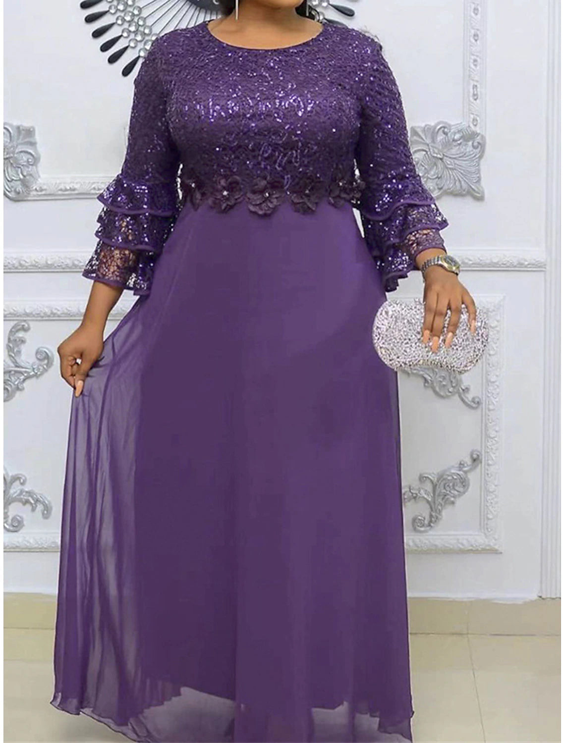 Close-up of the V-neckline and delicate lace fabric on the maxi dress.