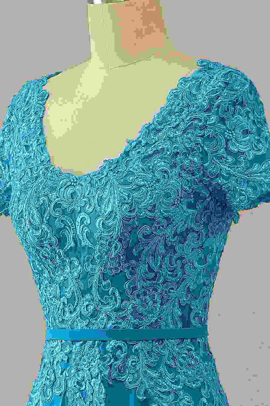 Close-up of the lace detail and sweetheart bodice on the blue gown.