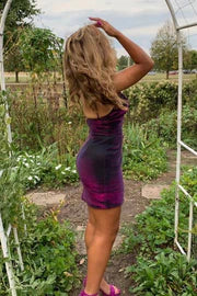 Close-up of the purple bodycon dress, showing spaghetti straps and fabric detail.