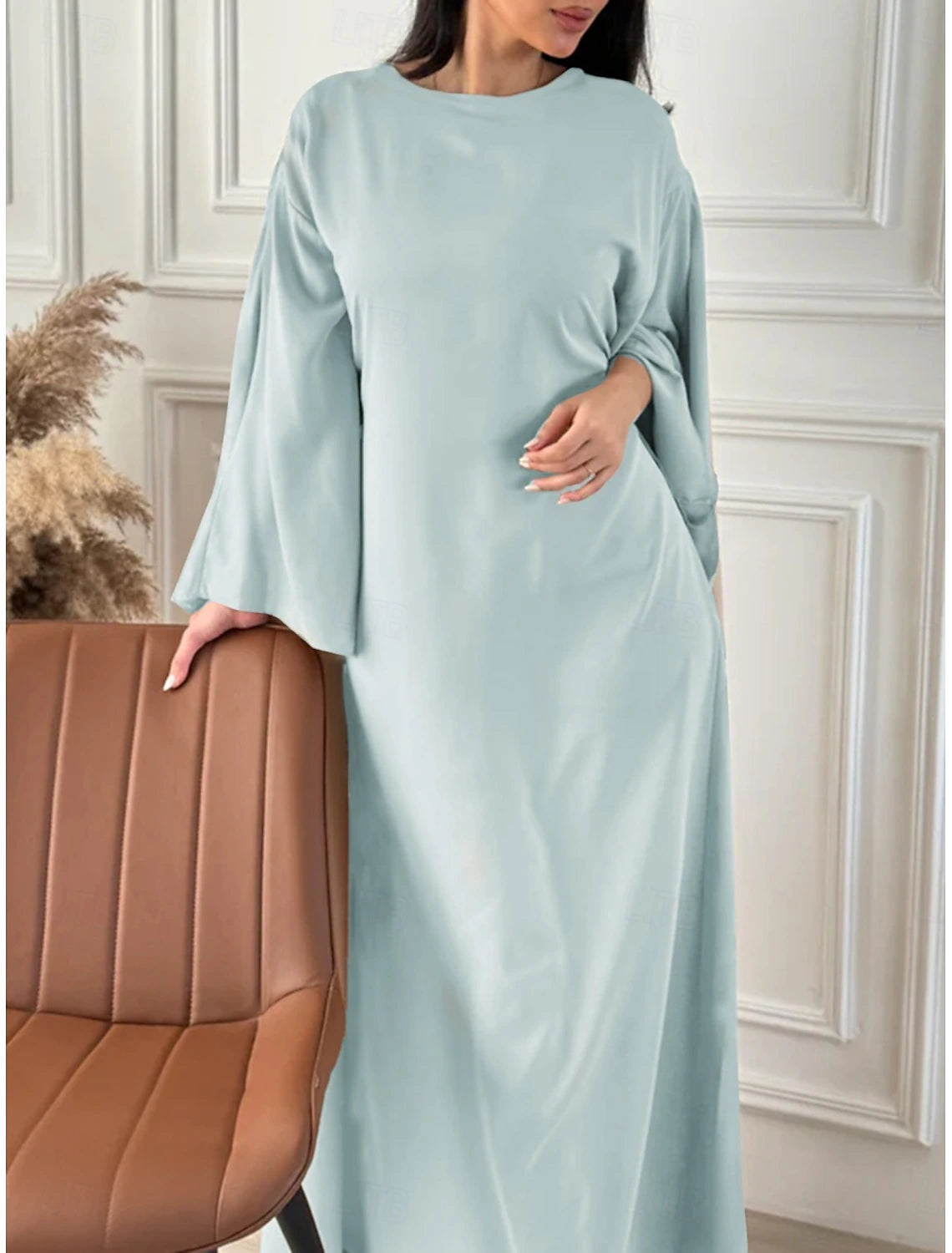 Woman wearing an elegant regular fit crew neck midi dress.