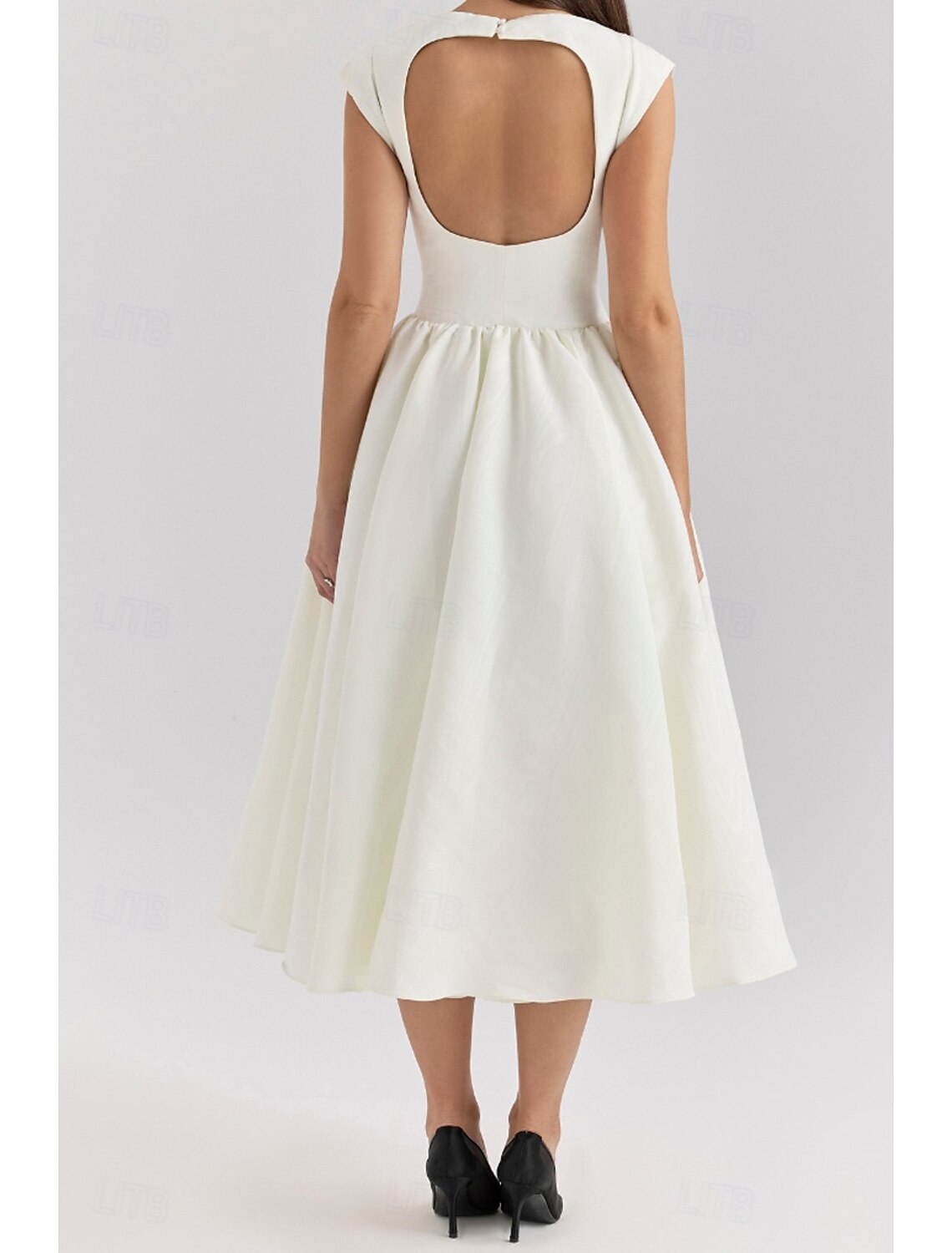 Woman wearing a beige regular fit sleeveless midi dress with a crew neck.