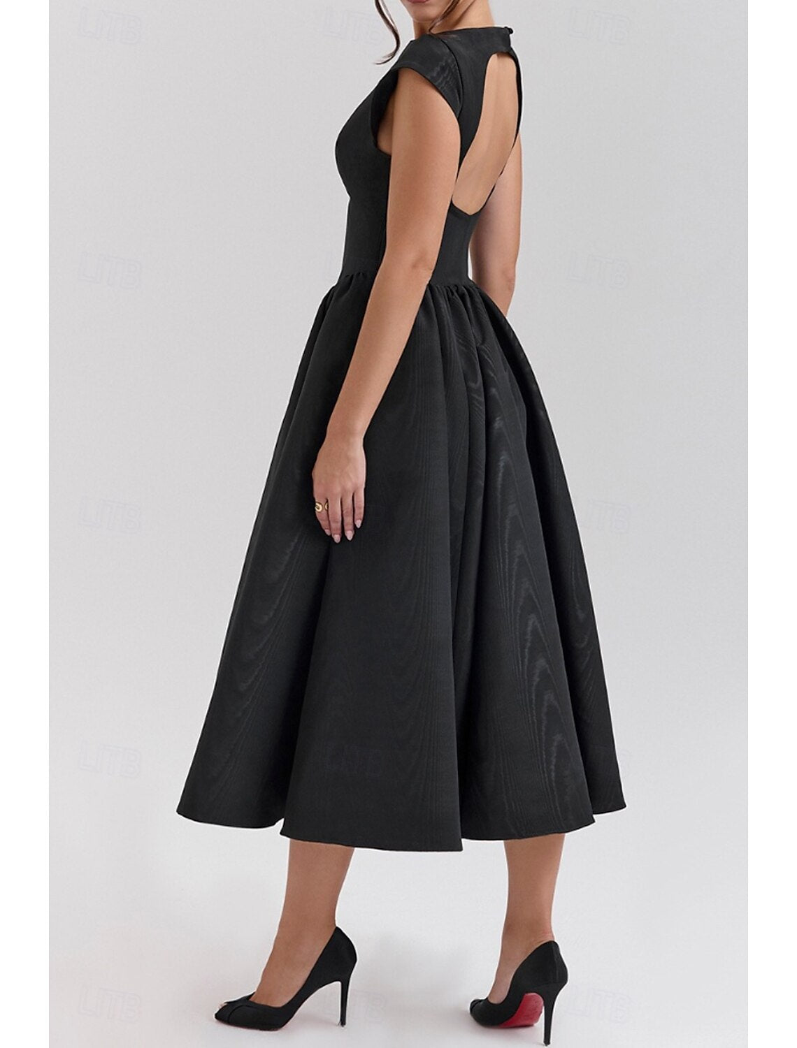 Woman posing in a black regular fit sleeveless midi dress.
