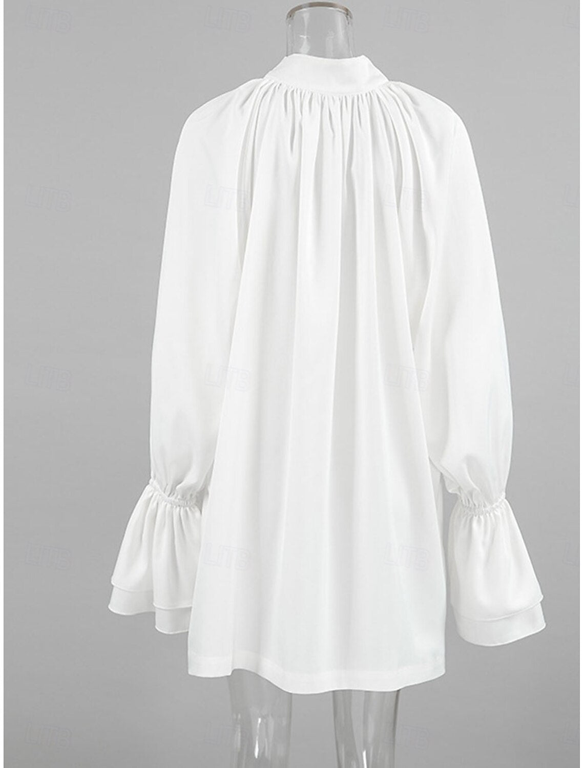 Side profile of a woman showcasing a casual long sleeve shirt with lace-up detail.