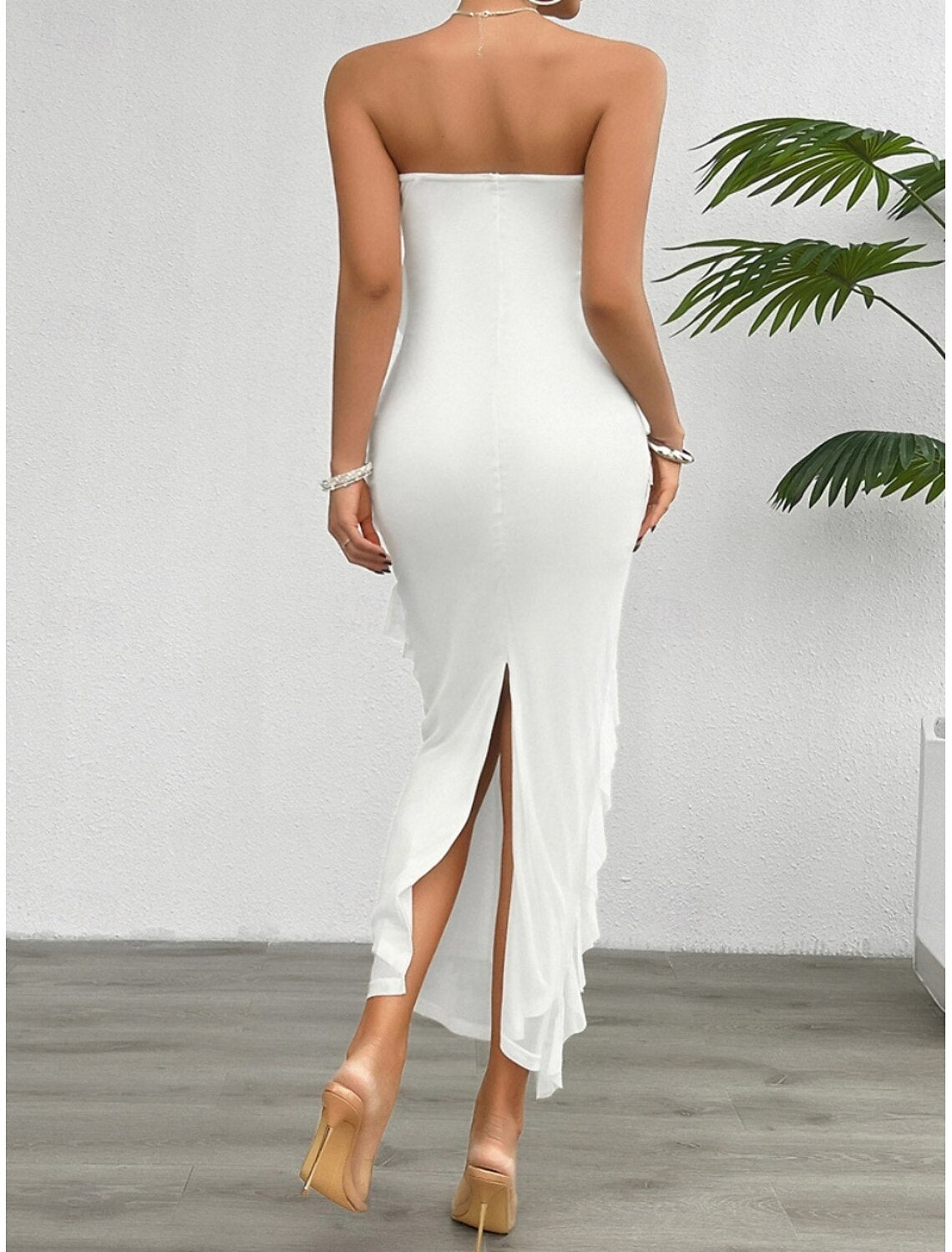 Back view of the white off-shoulder strapless prom dress on a model.