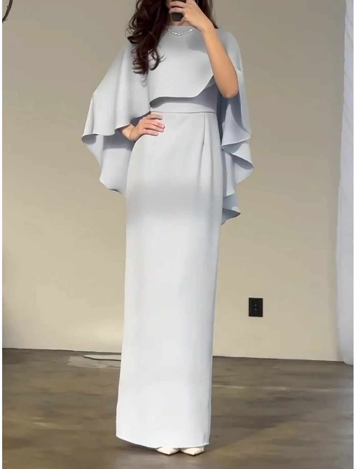 Woman wearing an elegant solid color short sleeve crew neck sheath dress.