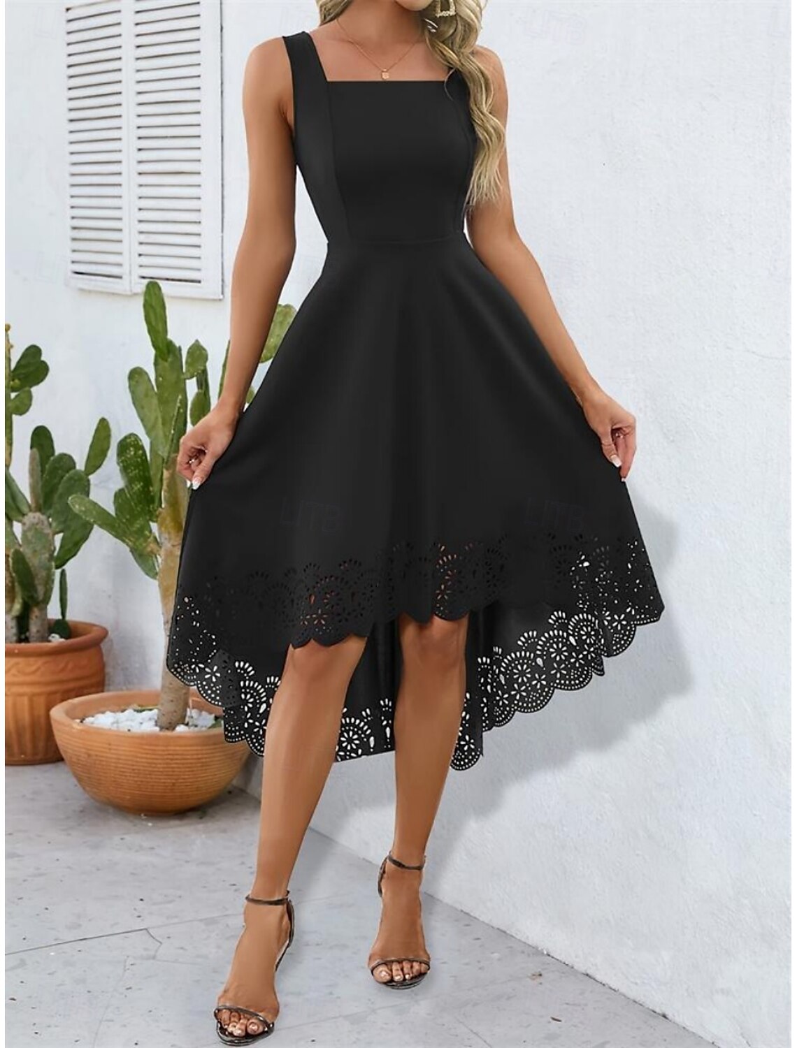 Black spaghetti strap slip dress worn by a model, front view.