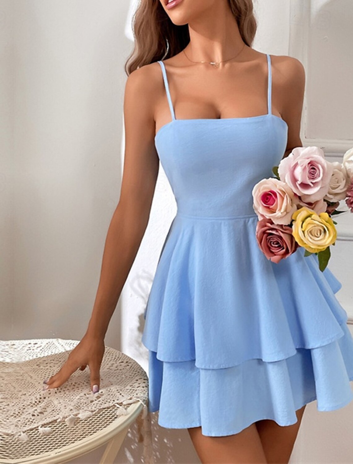 Front view of an elegant regular fit spaghetti strap slip midi dress.