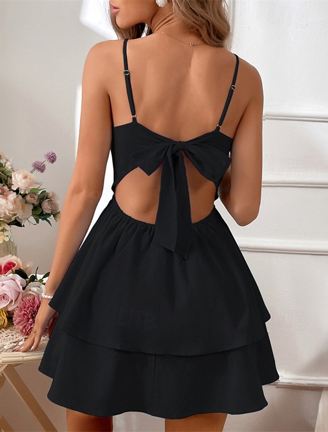Detail shot of the hemline and flow of the slip midi dress.