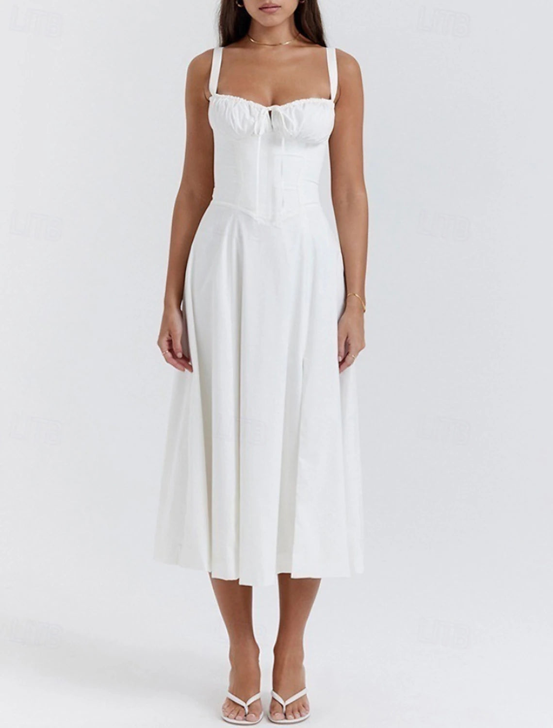 Woman wearing a white regular fit U-neck sleeveless midi dress, side view.