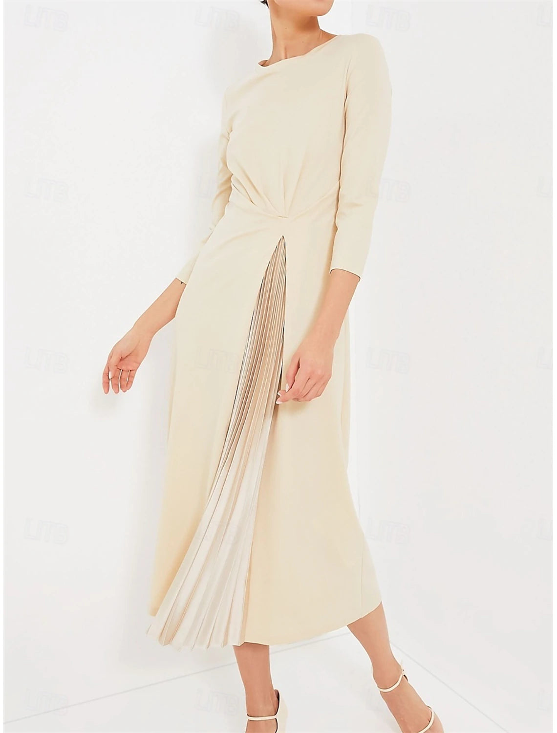 Woman wearing an apricot A-line midi dress with V-neck and 3/4 sleeves.
