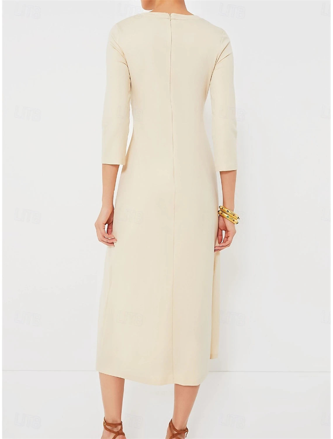 Back view of woman in elegant apricot V-neck midi dress.
