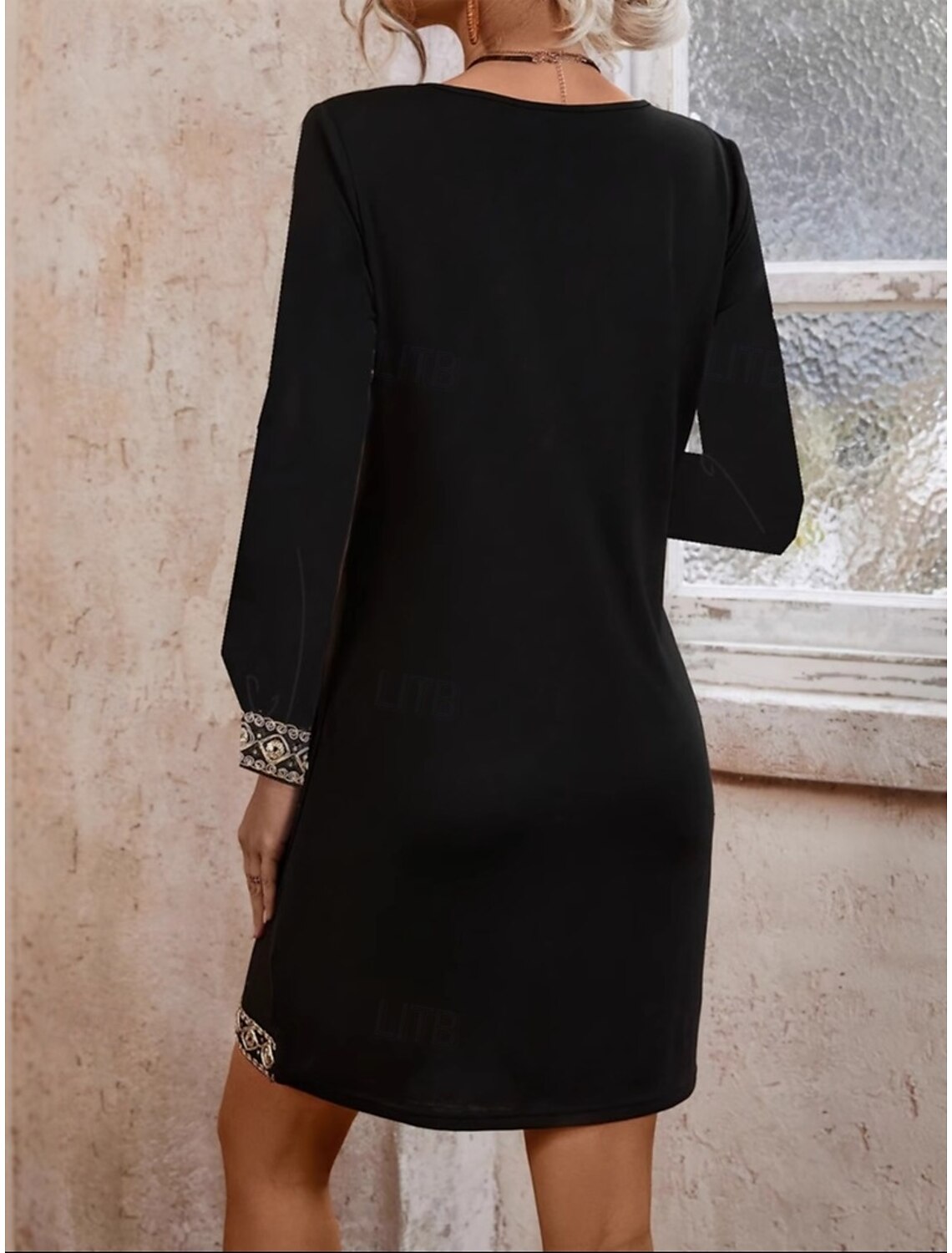 Stylish black V-neck long sleeve dress on a woman.