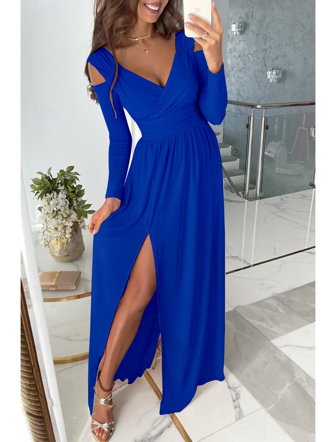 Woman wearing an elegant V-neck long sleeve maxi dress, suitable for prom or parties.