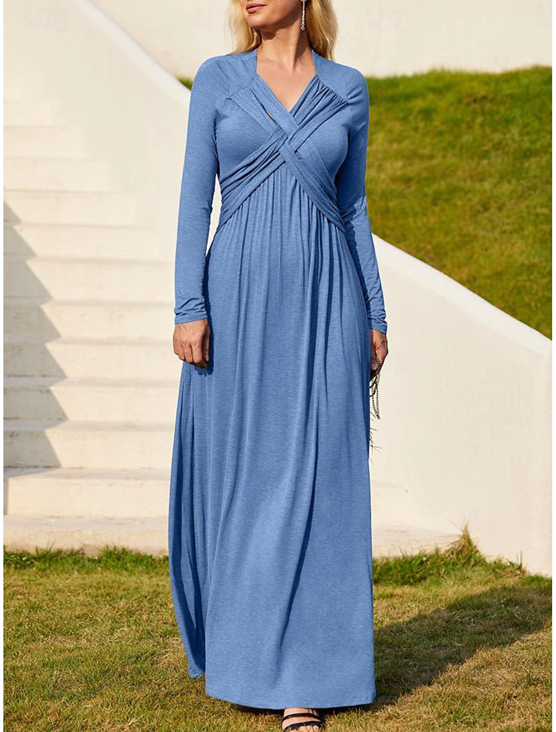 Woman wearing an elegant ruched V-neck long sleeve midi dress, suitable for work or parties.