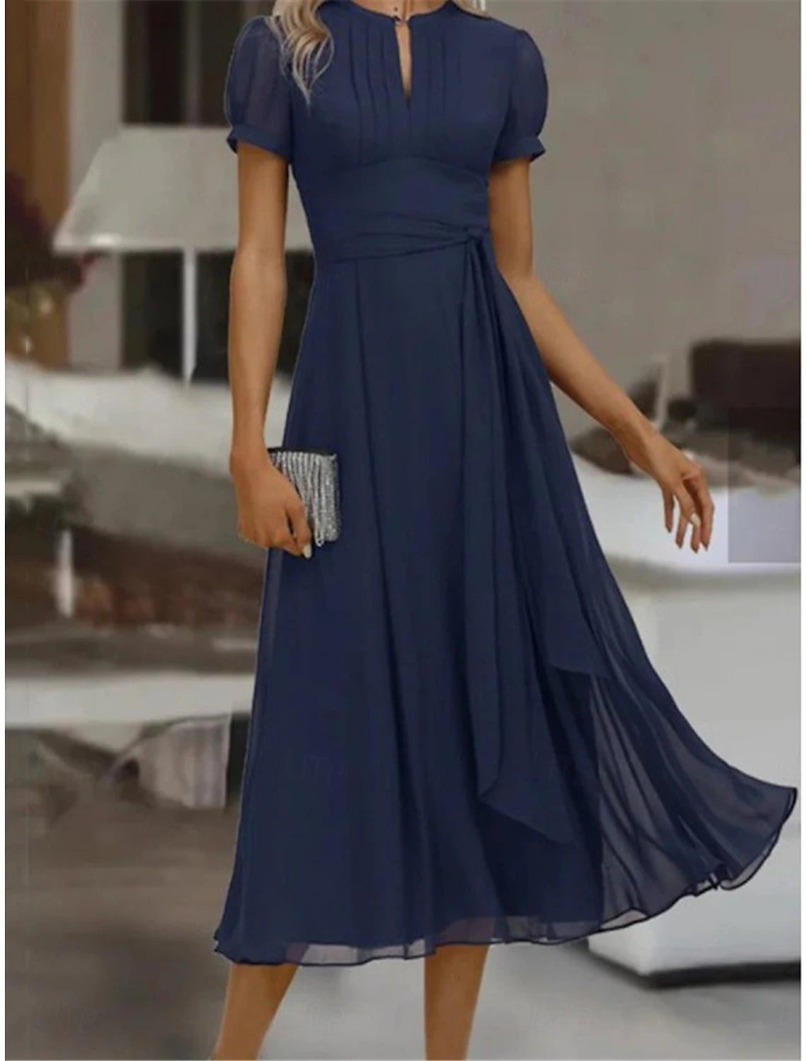 Woman in an elegant light chiffon ruffle maxi dress, perfect for wedding guests or cocktail parties.