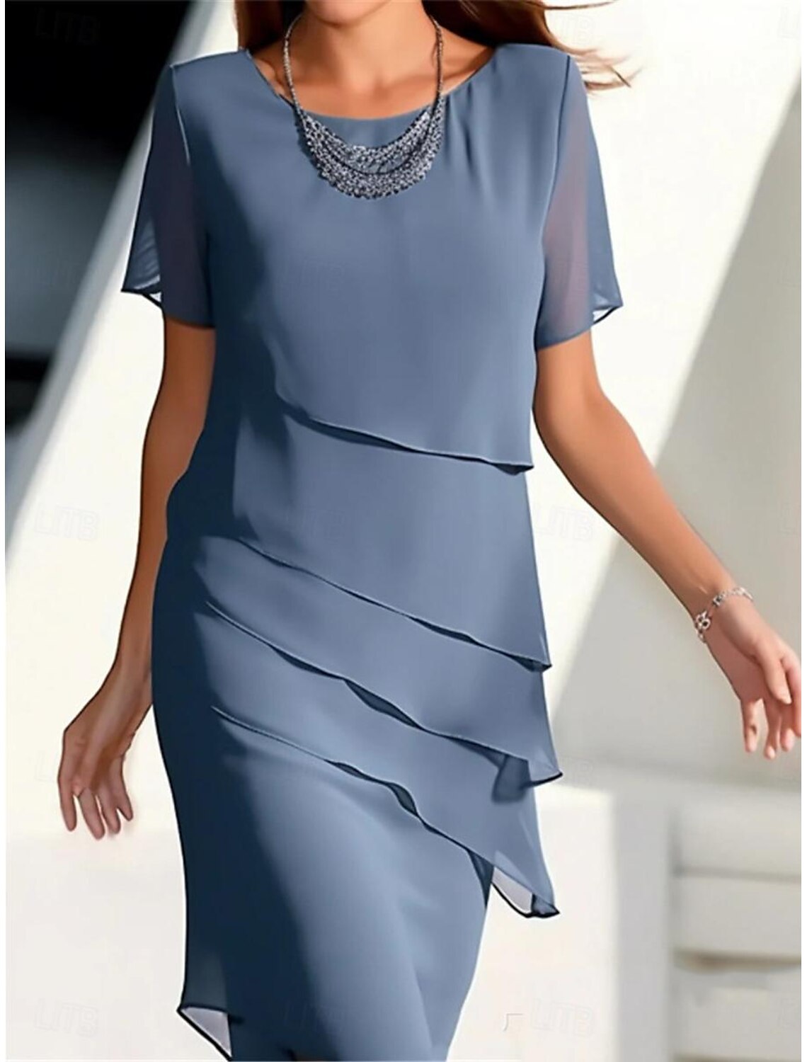Blue sleeveless midi dress with ruffle details and a crew neck.