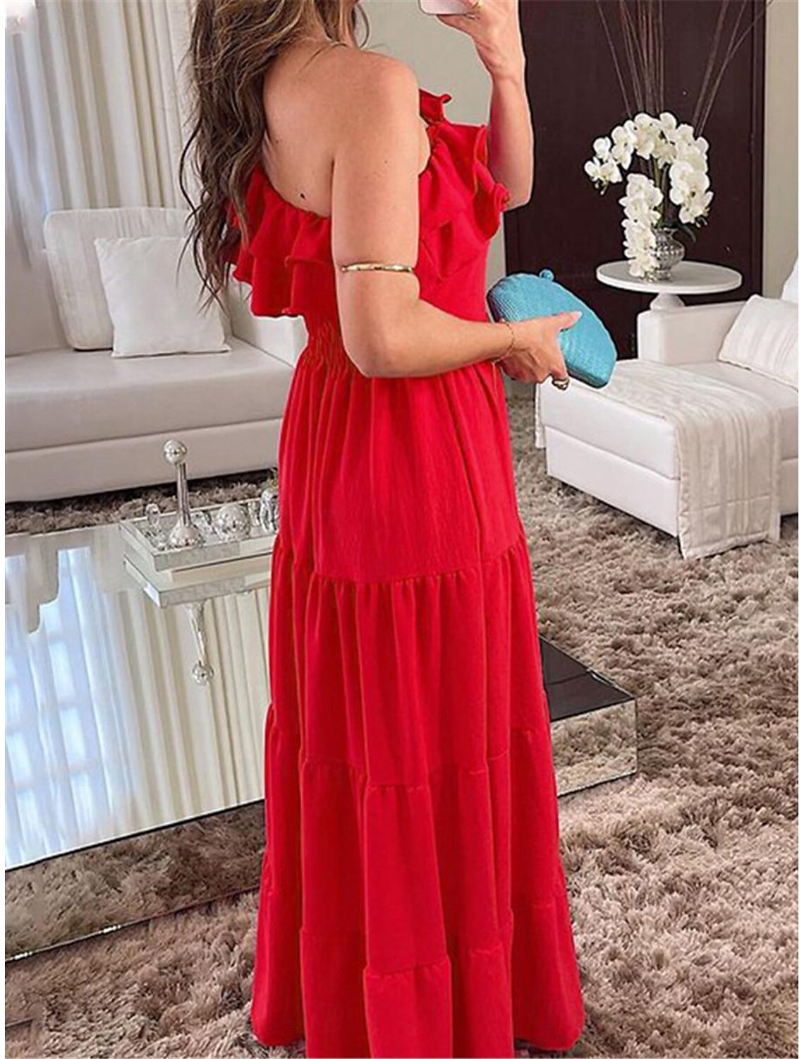 Black one-shoulder formal dress with ruffle detail.