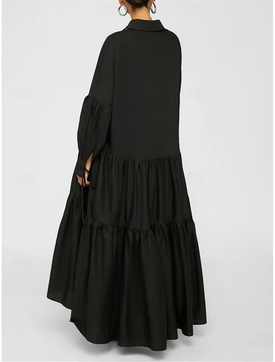 Close-up of the ruffle and shirt collar details on a black maxi dress.