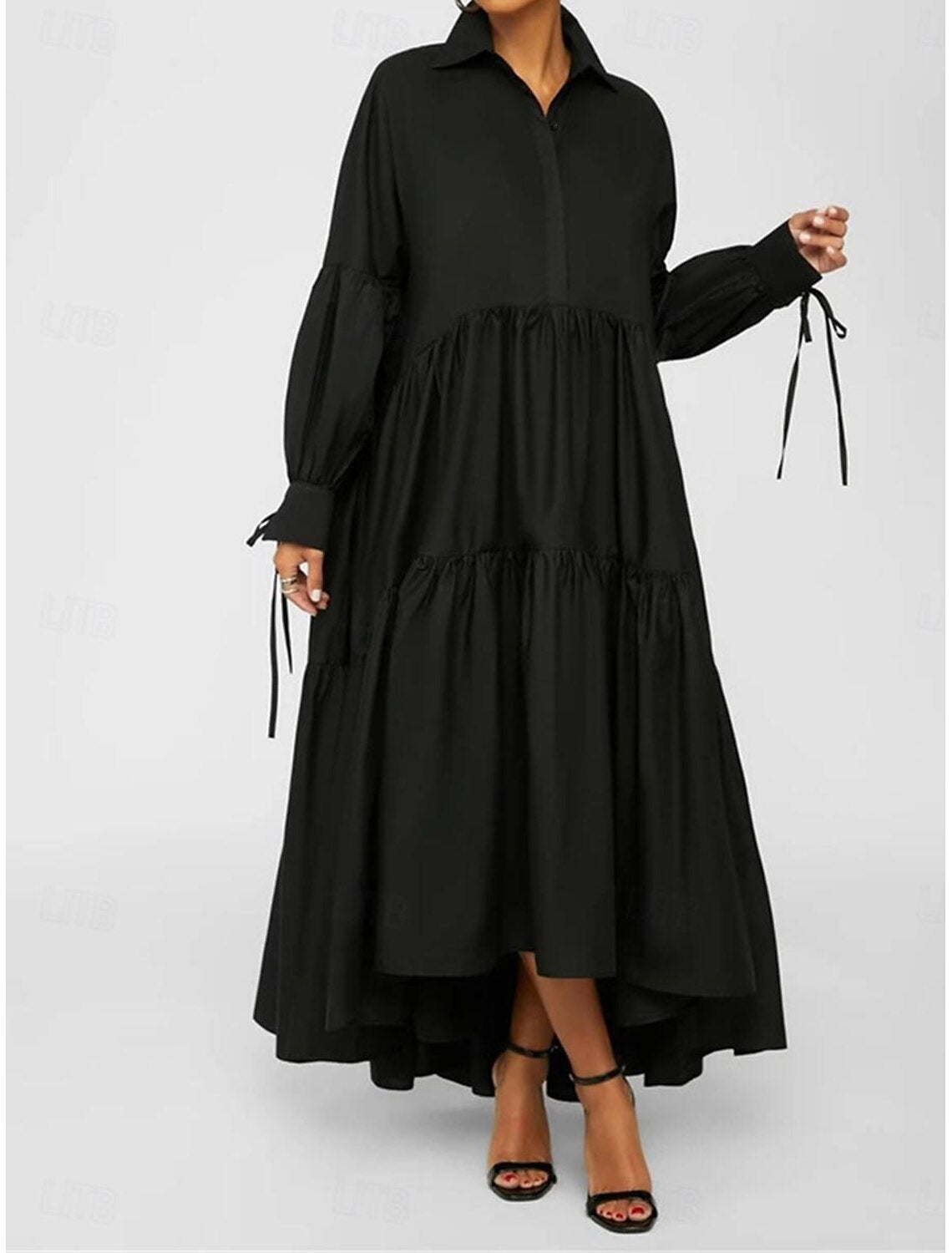 Back view of a woman wearing a black ruffle shirt collar long sleeve maxi dress.