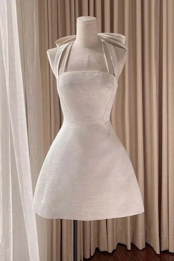 Full length view of a model in a light pink satin A-line mini dress, perfect for homecoming.