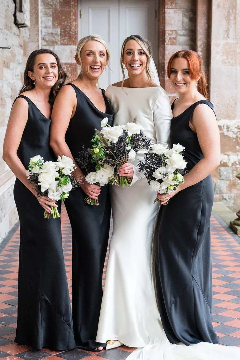 Model wearing an elegant black satin cowl neck long bridesmaid dress.