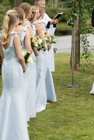 Close-up of the elegant satin bridesmaid dress, highlighting the delicate straps, bow, and pleated bodice.