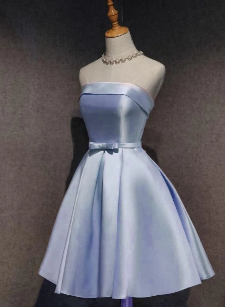 Woman wearing an elegant sky blue satin sleeveless short homecoming dress.
