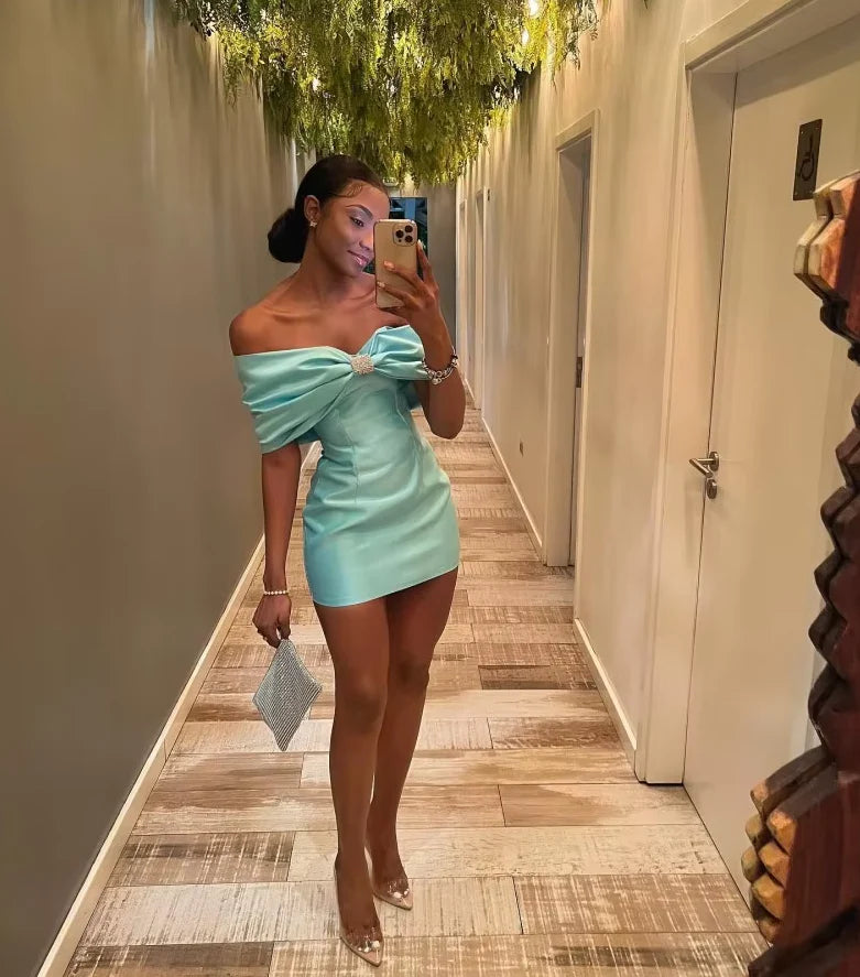 Model wearing a Tiffany Blue satin slim-fit dress, side view.