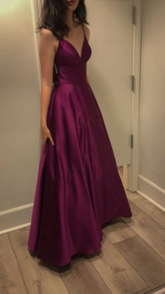 Elegant deep blue satin evening gown with spaghetti straps and a V-neckline.
